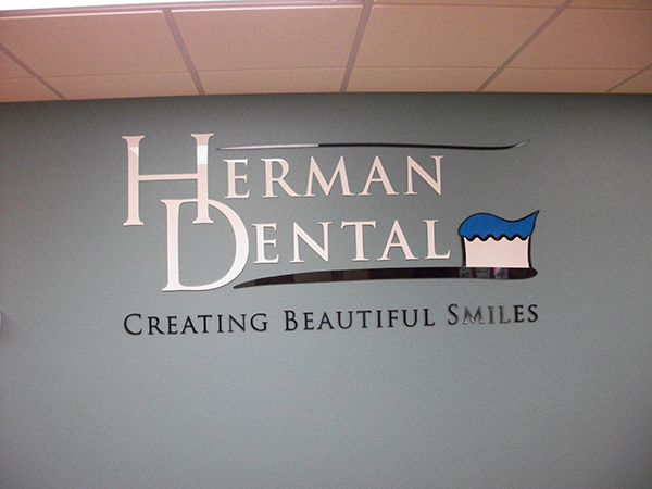 Laser cut acrylic dimensional wall graphics for Herman Dental office wall